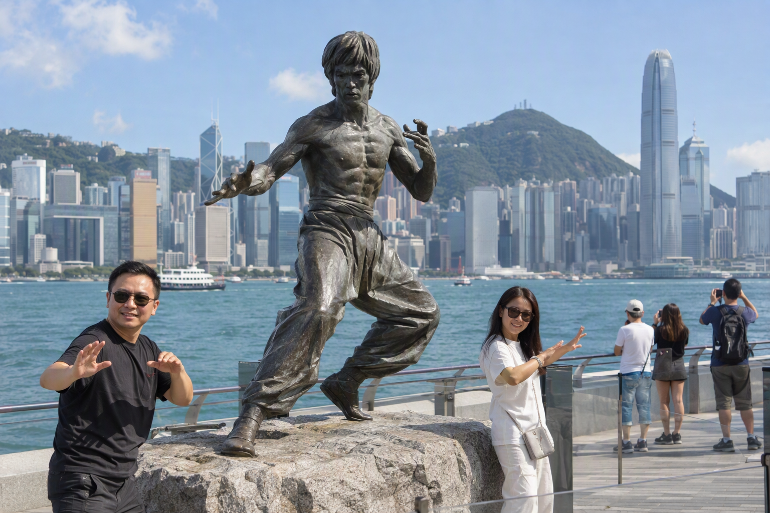 Visitors posing beside the bronze Bruce Lee statue on the Avenue of Stars in Hong Kong