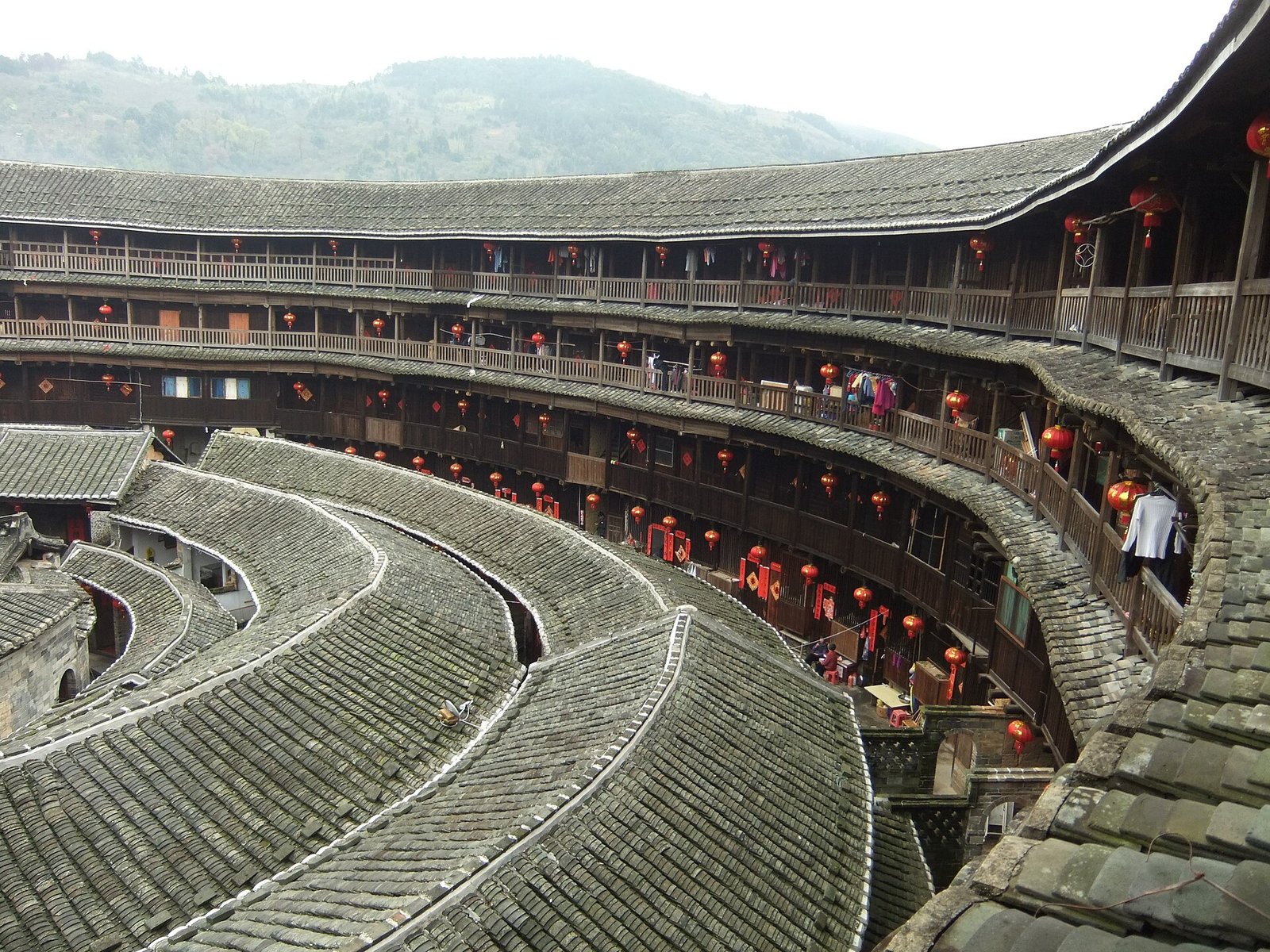 Fujian Tulou: A Traveller's Guide to Hakka Earth Castles 4 The interior courtyard and tiered wooden galleries of Chengqi Lou, the largest circular tulou in Yongding