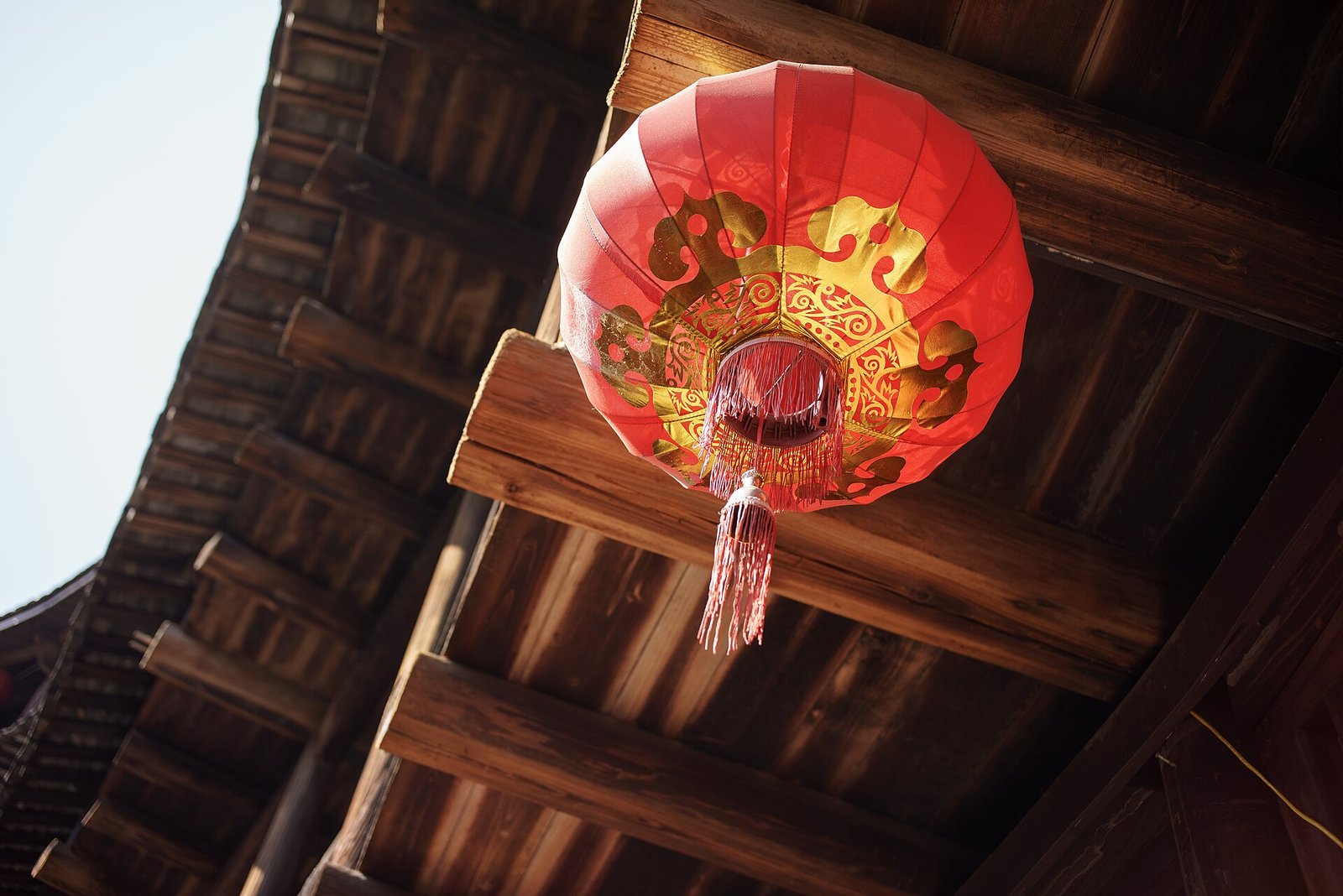 Fujian Tulou: A Traveller's Guide to Hakka Earth Castles 3 A red paper lantern beneath the timber eaves of a tulou in Fujian