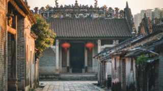 Illustration of a traditional Tang-clan walled village in Hong Kong's New Territories at golden hour