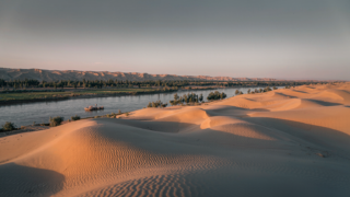 Shapotou desert and Yellow River landscape with Tengger Desert dunes above the river bend