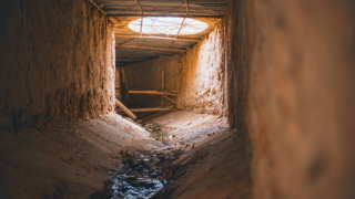 Turpan karez underground canal with meltwater running along the tunnel floor