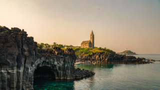 AI-generated illustration of Weizhou Island's volcanic coastline, coral-stone church and fishing boats