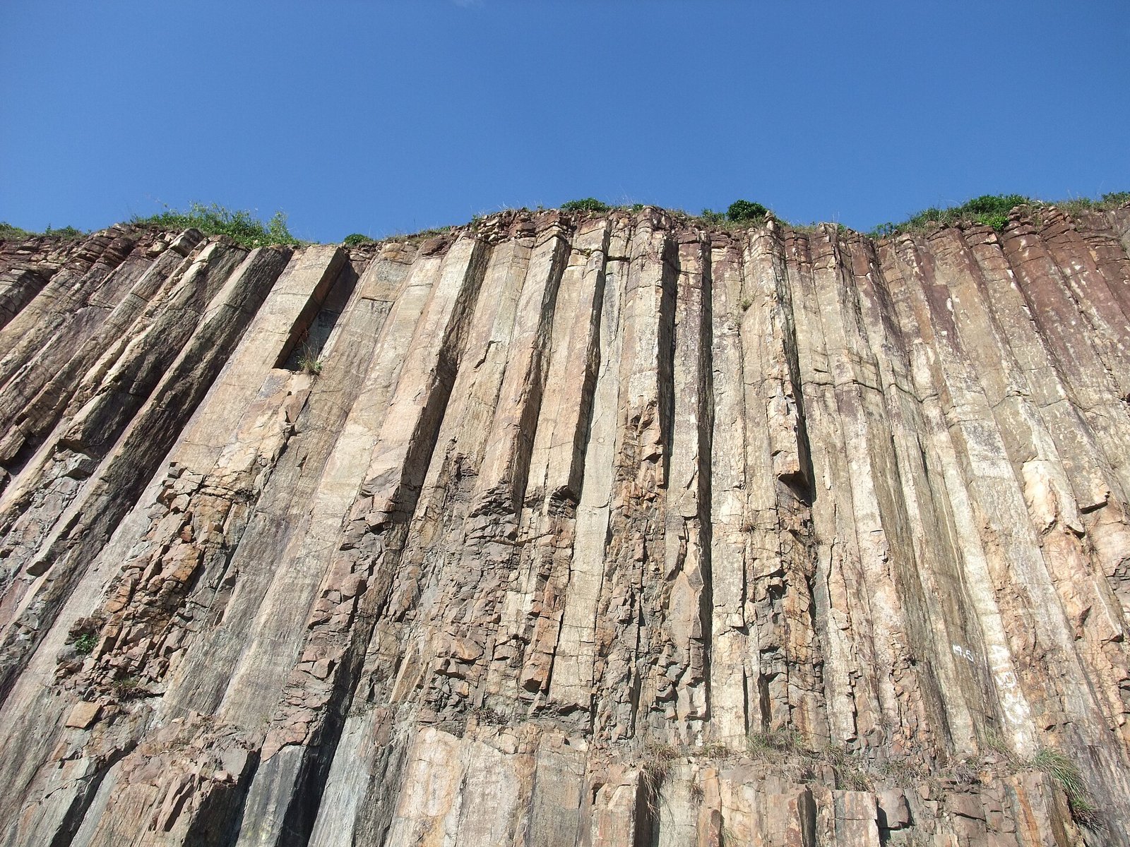 Hong Kong Geopark: Walking Among Hexagonal Stone Giants 2 Close-up of pale grey hexagonal rhyolitic volcanic columns at the East Dam of High Island Reservoir