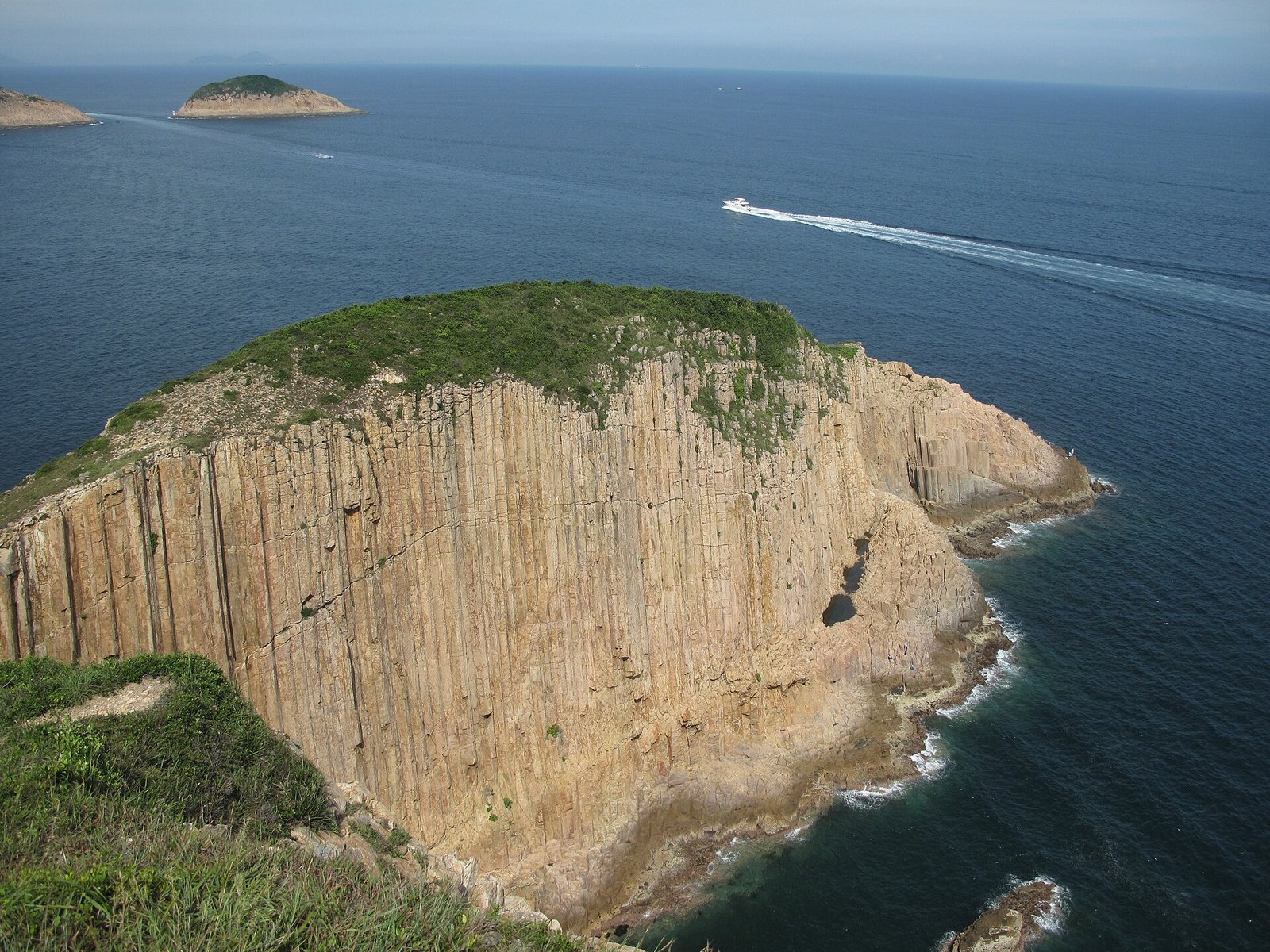 Hong Kong Geopark: Walking Among Hexagonal Stone Giants 5 Po Pin Chau sea stack with vertical hexagonal rock columns rising from the sea