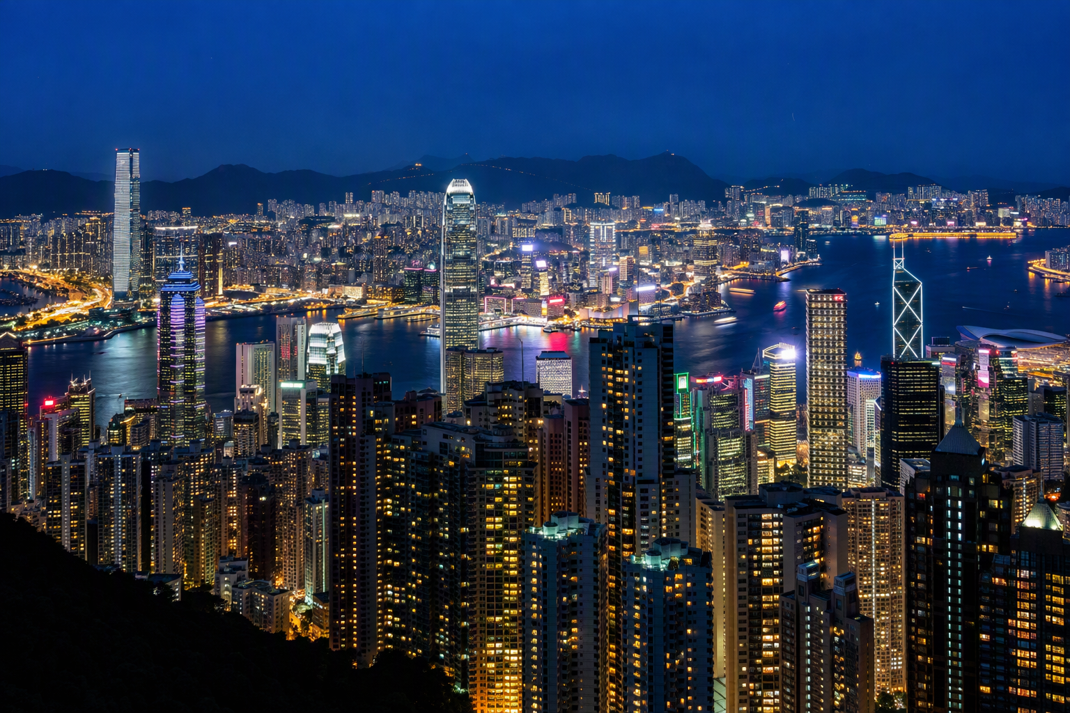 Panoramic night view of the Hong Kong skyline and Victoria Harbour seen from Victoria Peak