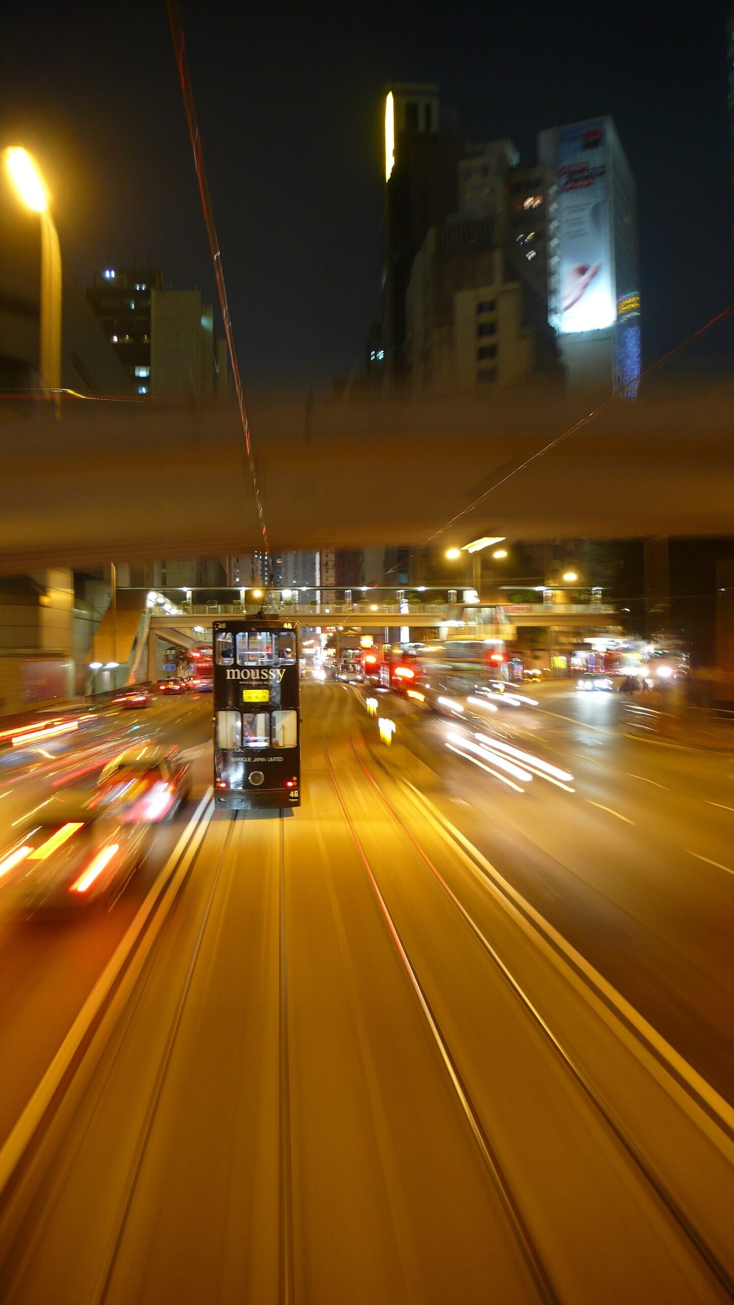 Hong Kong tram at night among city lights