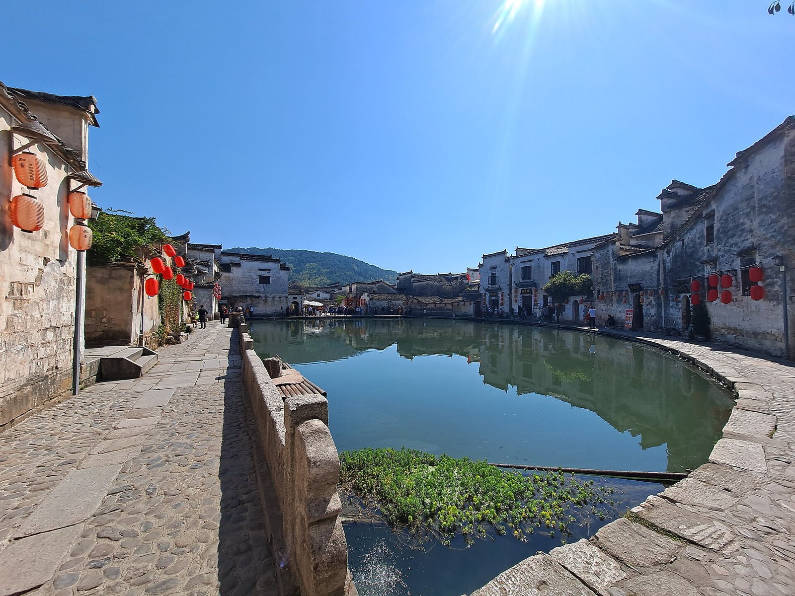 Moon Pond in Hongcun, Yixian County, ringed by white Huizhou houses and red lanterns