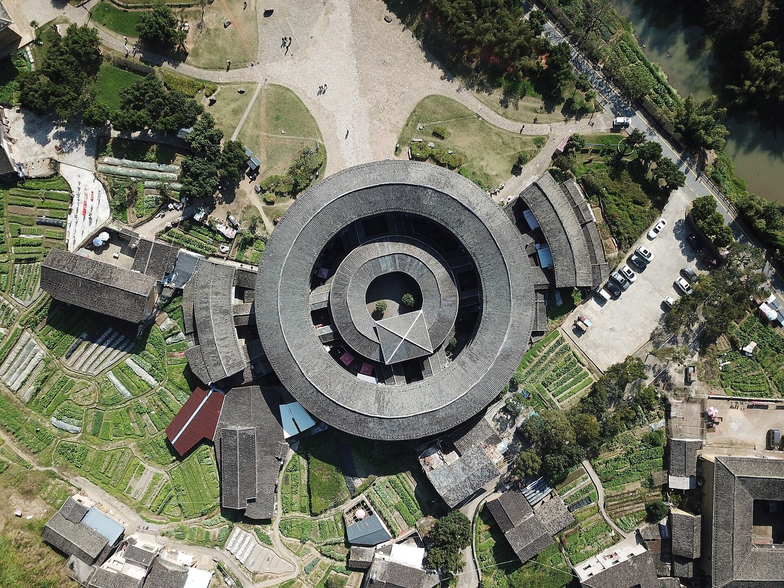 Fujian Tulou: A Traveller's Guide to Hakka Earth Castles 2 Aerial view of a circular tulou in Yongding, Fujian, surrounded by vegetable plots and fields