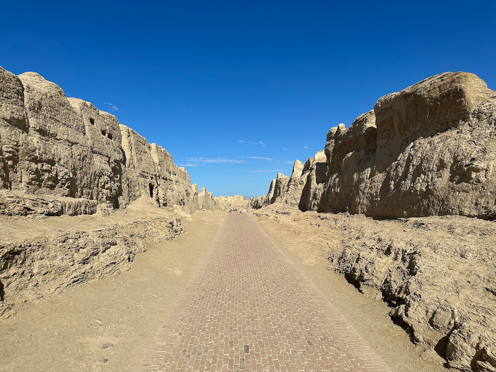 Central Avenue of Jiaohe ancient city, mud-brick ruins cut into the plateau in Turpan