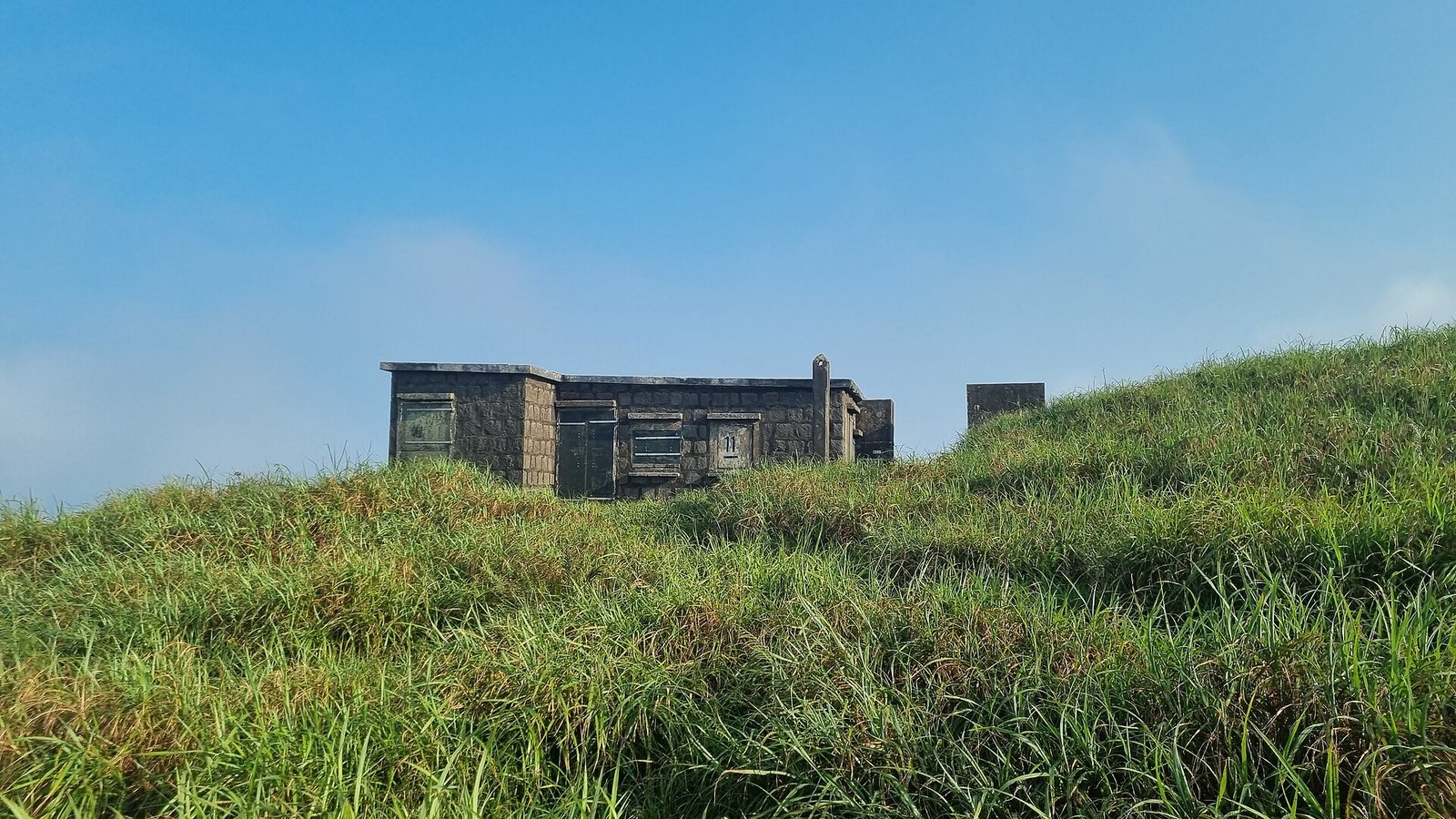 One of the 1920s stone huts of the Lantau Mountain Camp on the grassy upper slopes of Sunset Peak