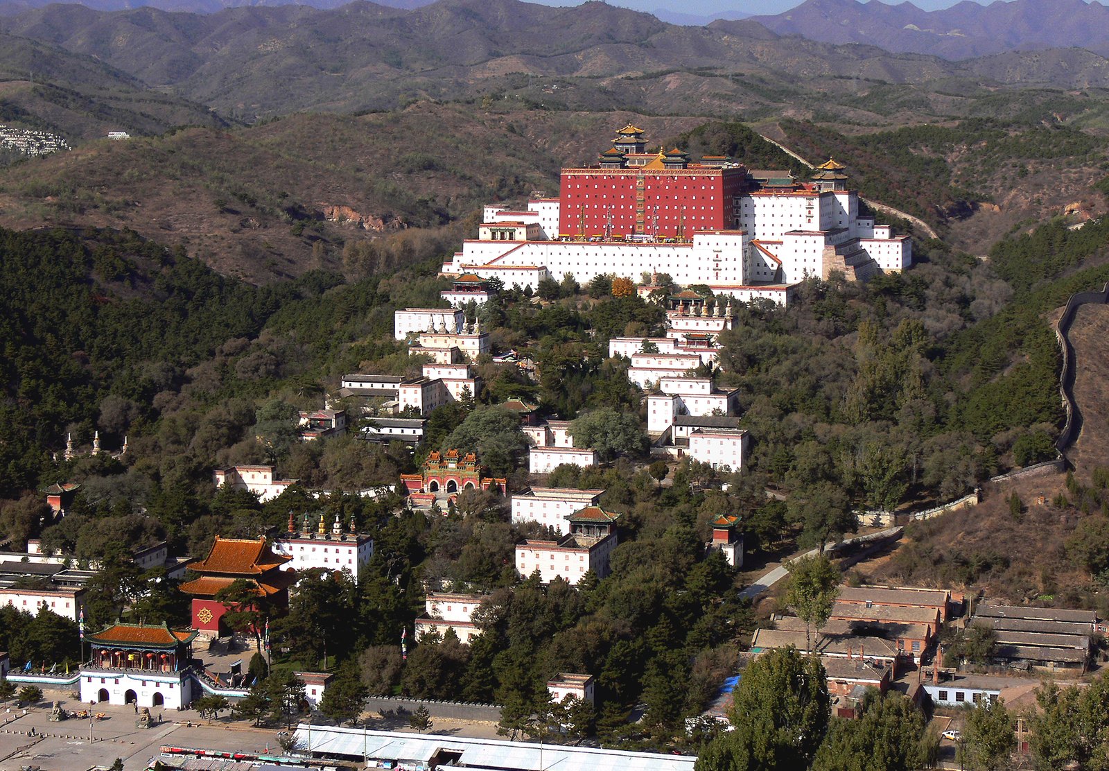 Chengde Mountain Resort: Imperial Autumn Beyond the Wall 3 Aerial view of Putuo Zongcheng Temple at Chengde with its red terrace and white walls on a forested hillside