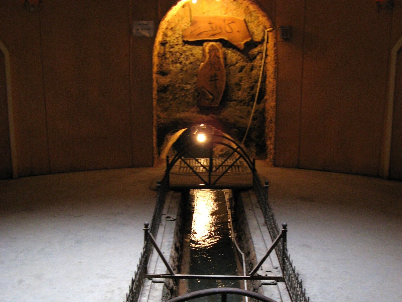 Underground karez tunnel with a channel of meltwater running through it at the Turpan karez water museum