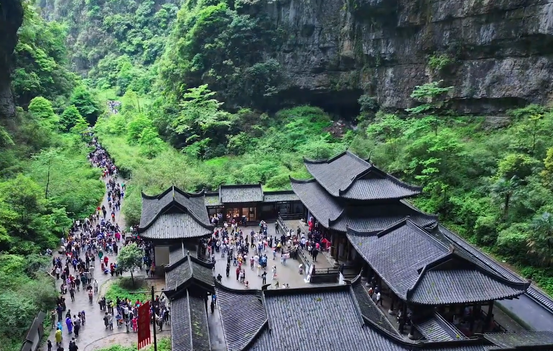 Wulong's Sinkholes: Descending Into China's Karst Underworld 1 Timber inn and stone path on the floor of the Wulong karst sinkhole beneath towering limestone cliffs