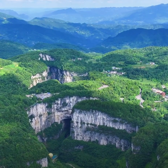 Wulong's Sinkholes: Descending Into China's Karst Underworld 4 Aerial view of the collapsed Wulong karst sinkhole ringed by forested cliffs and farmland