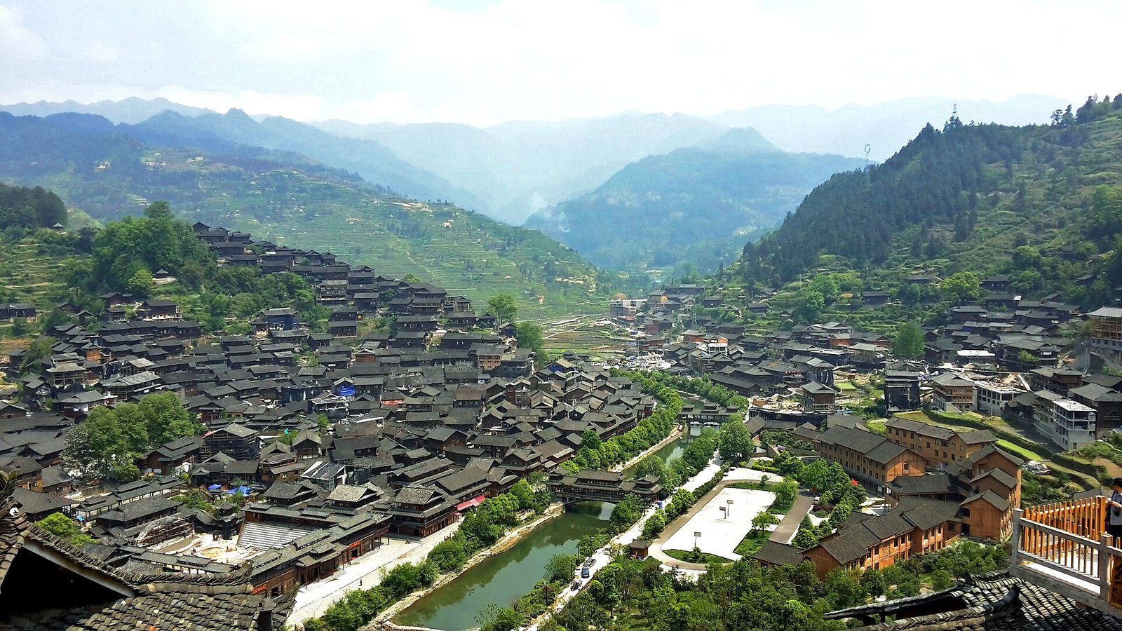 Xijiang: A Thousand Miao Households Lit Up at Dusk 1 Xijiang Miao Village skyline with timber stilt houses stacked across two hillsides in Guizhou