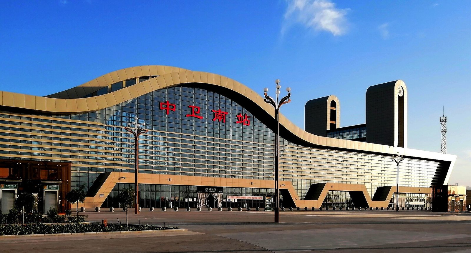 Zhongwei South railway station glowing at sunset, the high-speed rail gateway to Shapotou